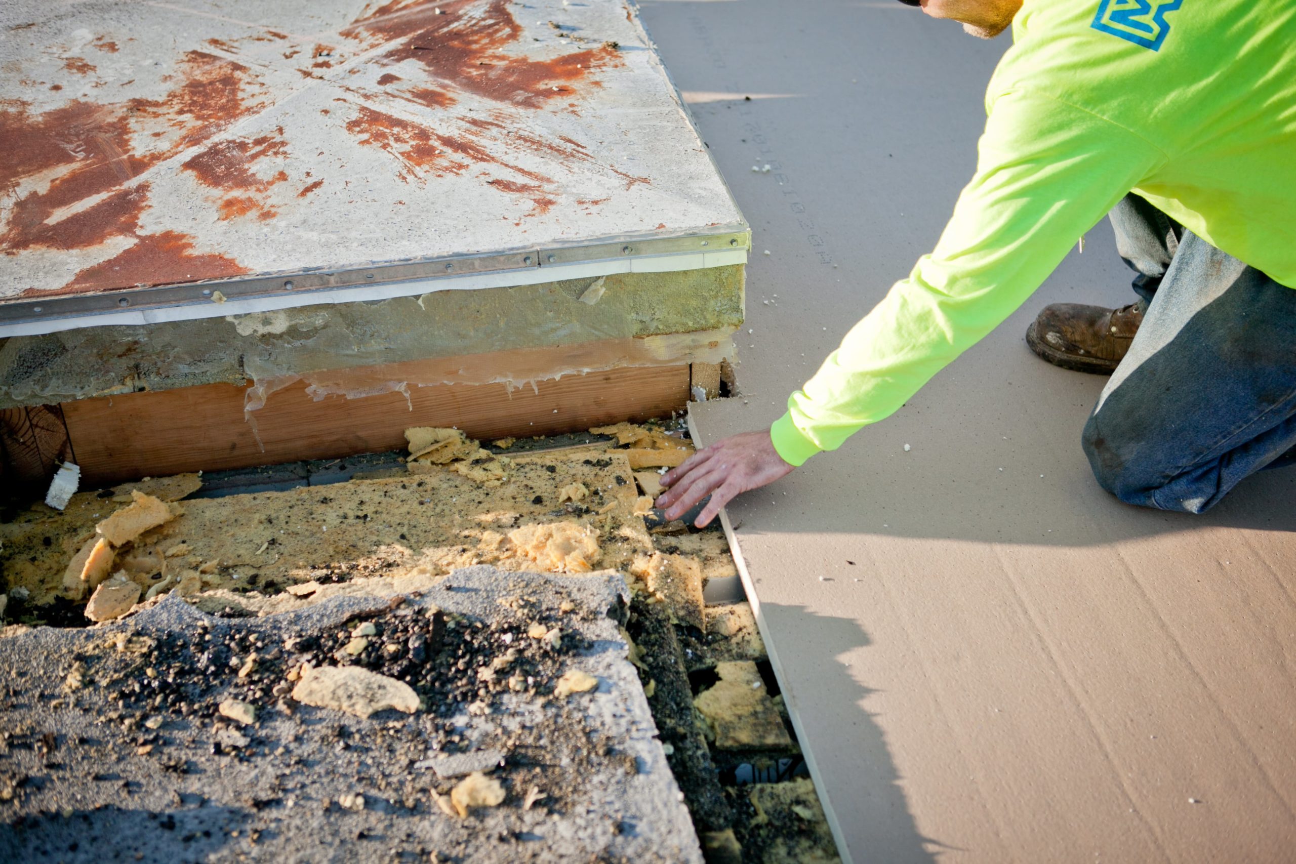 man repairing a commercial rooftop