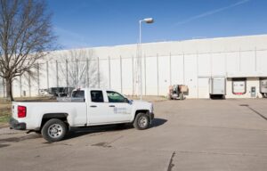 maxwell roofing truck parked at warehouse