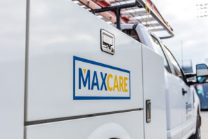 Maxwell Roofing Maxcare logo on roofing service truck