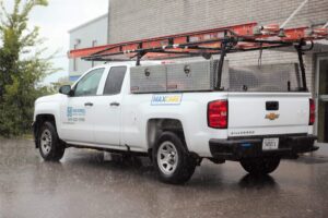 maxwell roofing commercial truck parked in the rain