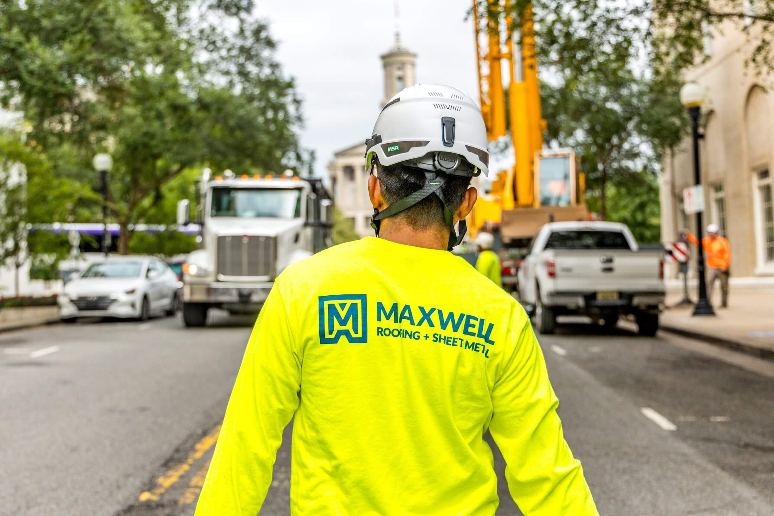 maxwell roofing employee walking down street