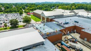 workers on commercial roof during a roofing project