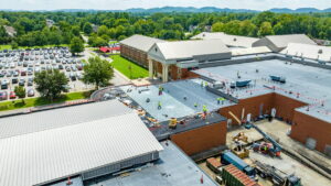 workers on a commercial roof during a roofing project