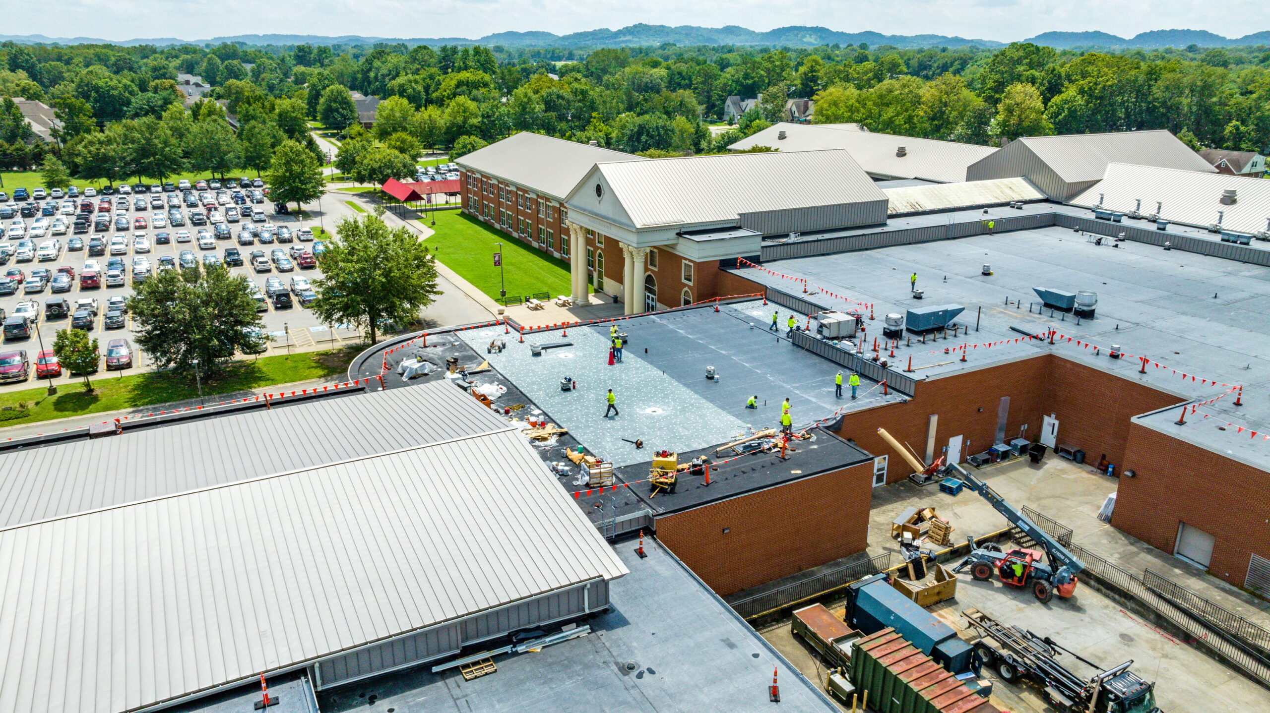 workers on a commercial roof during a roofing project