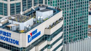 helicopter delivering roofing materials to downtown building