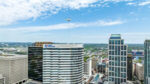 helicopter delivering roofing materials to downtown high rise