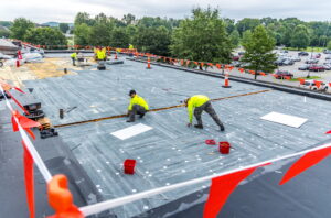 maxwell roofing team working on a commercial roof project