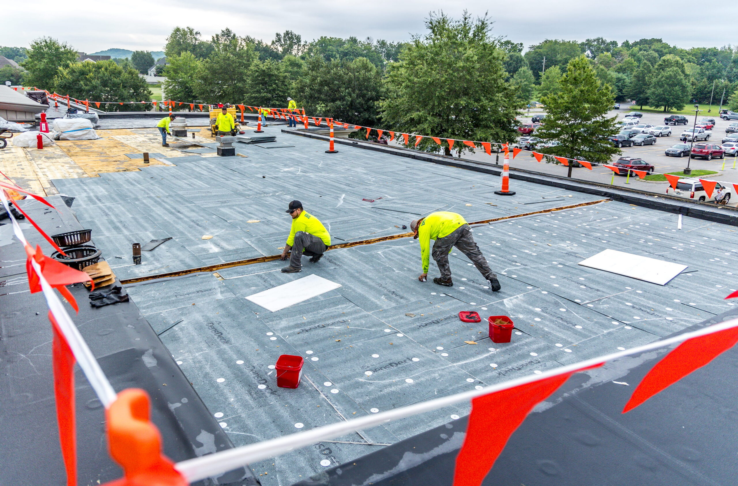maxwell roofing team working on a commercial roof project